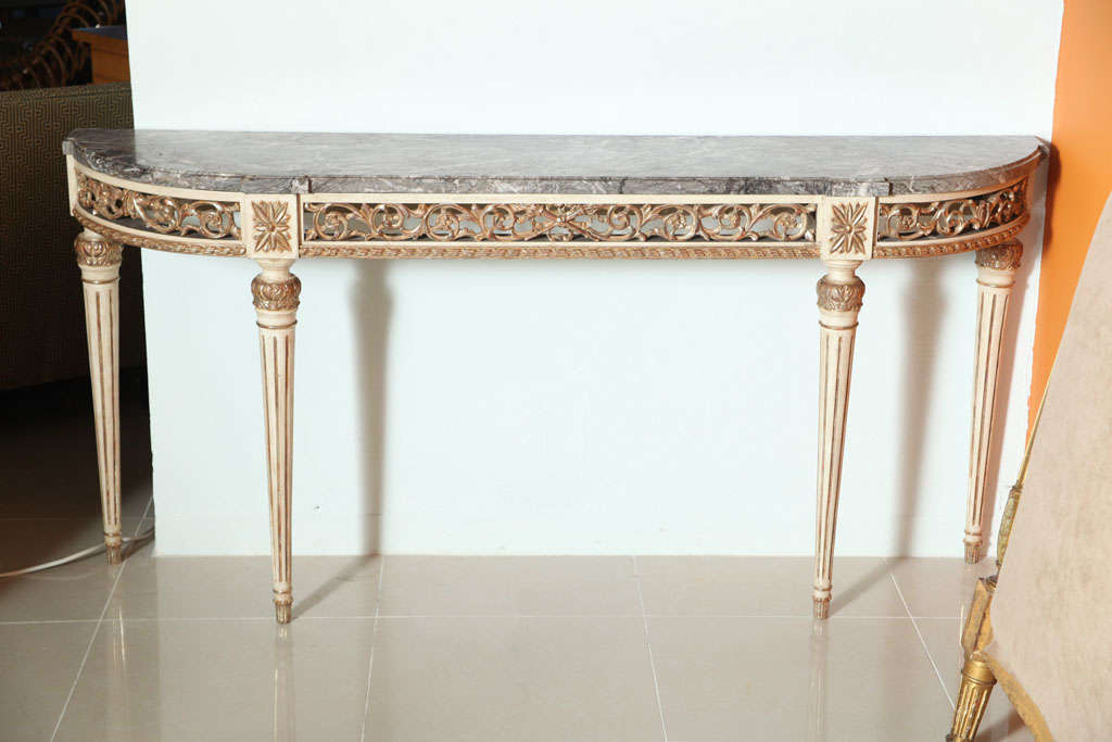 The st clous marble top above a pierced frieze resting on round fluted legs, stamped JANSEN to rear top under marble.