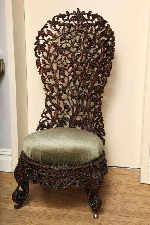 A Hand Carved Rosewood Burmese Slipper Chair In Excellent Condition In New York, NY