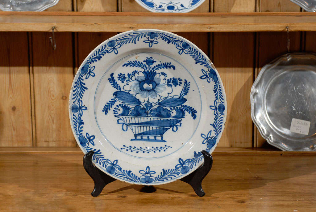 Large blue and white charger with flora center design and border