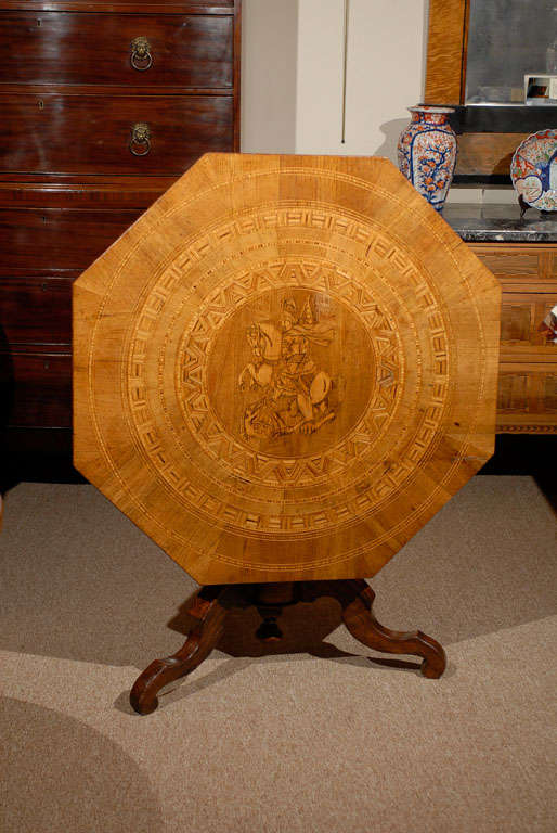 An octagonal sorrento tilt-top table with inlaid top of a geometric design and central warrior figure on horse. The top resting on a tripod base. 

For many more fine antiques, please visit our online gallery.

William Word Fine Antiques: