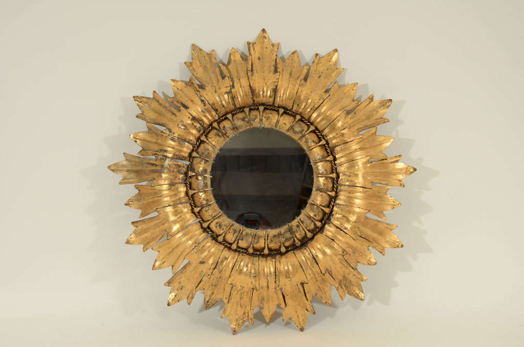 Vintage Gilt Tole Sunburst Mirror in Foliate Design. <br />
Spain, Early to Mid 20th Century<br />
<br />
Center Glass Mirror  8 inches diameter<br />
Gilt Tole Frame     26 inches diameter