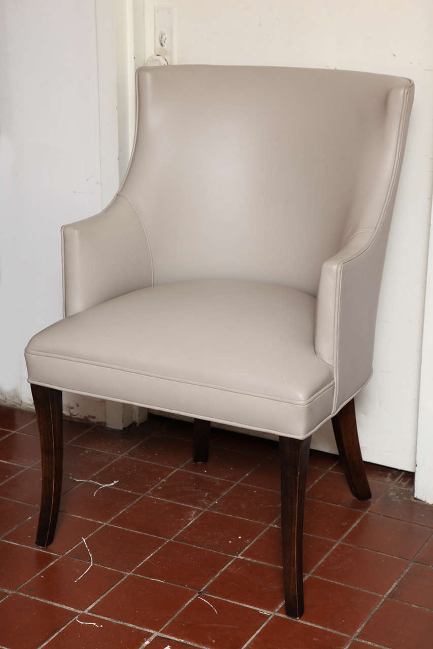 The Small and Geometrical Wing back makes this chair very special. This Superb Neoclassical Armchair has splayed, sabre-form legs in chocolate oak finish. And its complemented in updated cream leather upholstery.
