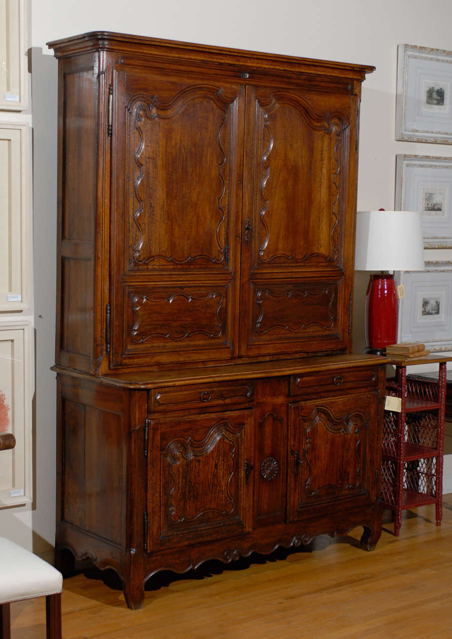 This is a lovely French Buffet Deux Corps of beautiful fruit wood.  Buffet Deux Corps are buffets with a top cabinet as well as a bottom.  This Buffet deux corps has lovely carvings and cabriole legs.  The details are handsome.