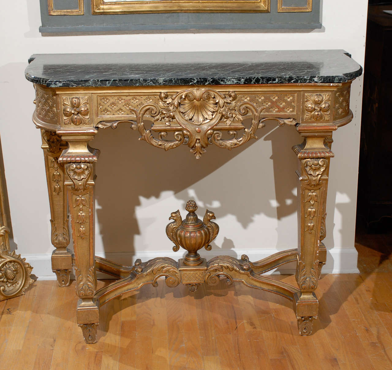 Louis XVI Console, gilt - green marble

A Louis XVI revival style console table, green and black veined conforming marble top,  carved wood and gesso console with a central leaf fan with swags and scrolls,  Carved frieze with diamond and