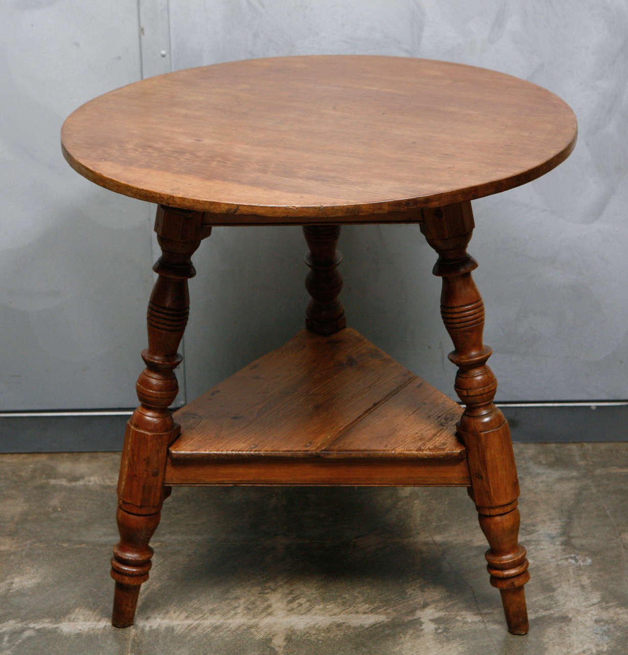 This antique cricket table is a nice example of the quintessential English occasional table. This table can be used with any seating arrangement in your home.