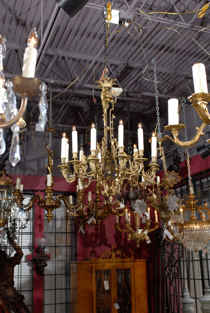 Superb gilt bronze French Regence style chandelier with ten lights, originally for candles