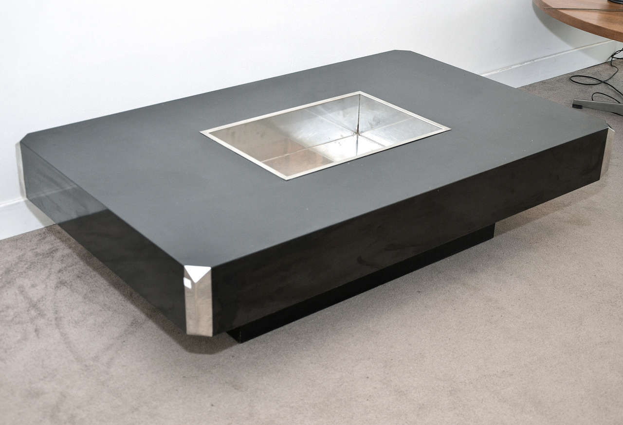 1970s Italian coffee table in black melamine and corners in chromed metal; central stainless metal container. One nick on a lateral edge (see view 8); some scratches. Normal wear consistent with age and use.