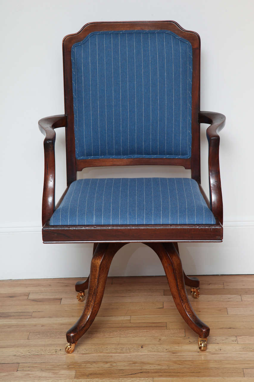 Regency Mahogany Chair with new brass casters and newly upholstered in a Holland and Sherry blue stripe fabric 
Arm height is 26