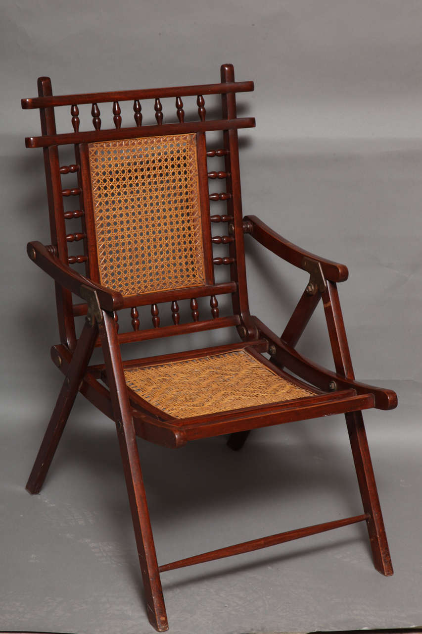 Fine quality English 19th Century teak and rattan folding deck chair having attractive form and lovely color.