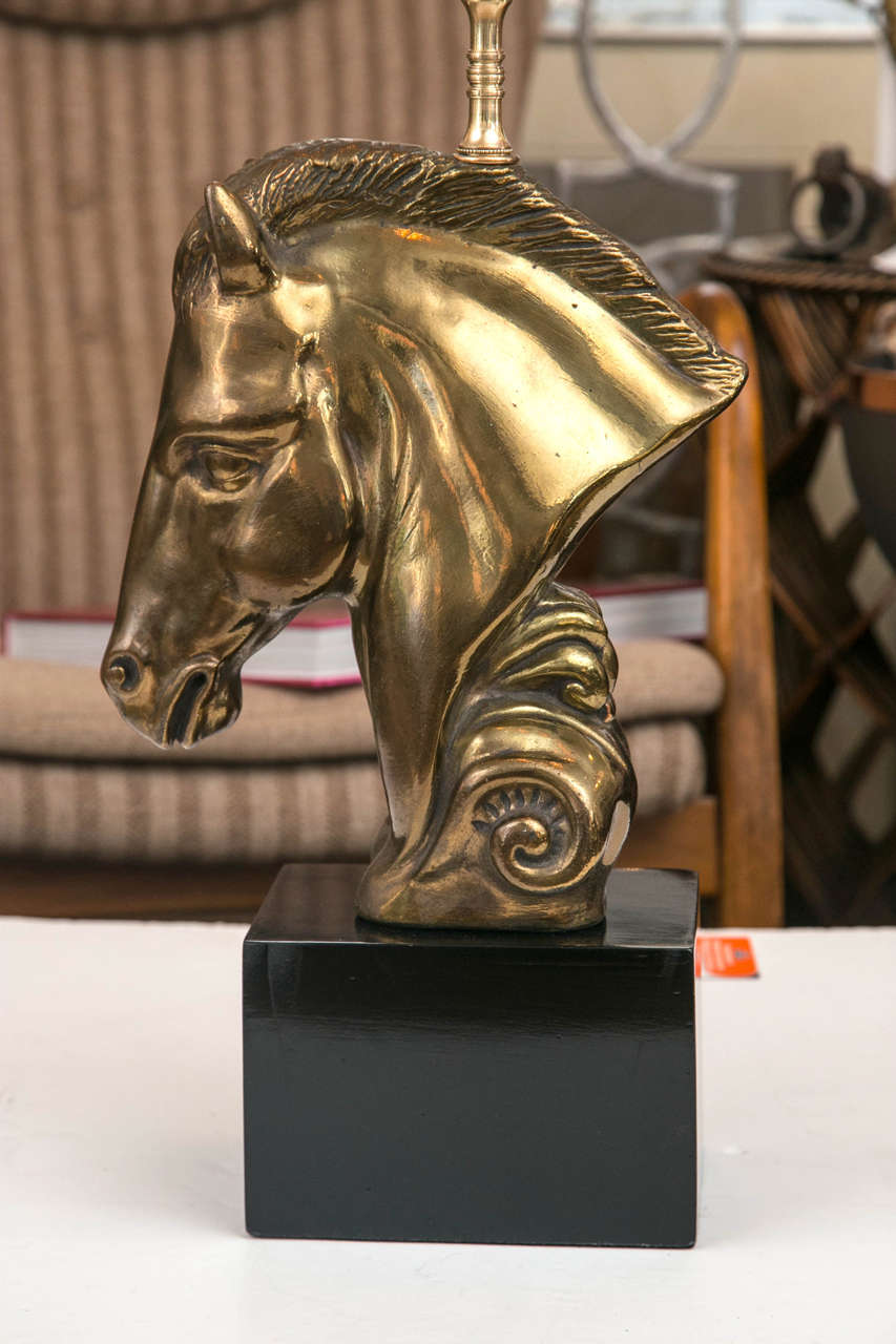 A bronze tone, stylized horse head on a black lacquered cube form base. All wiring is new.
