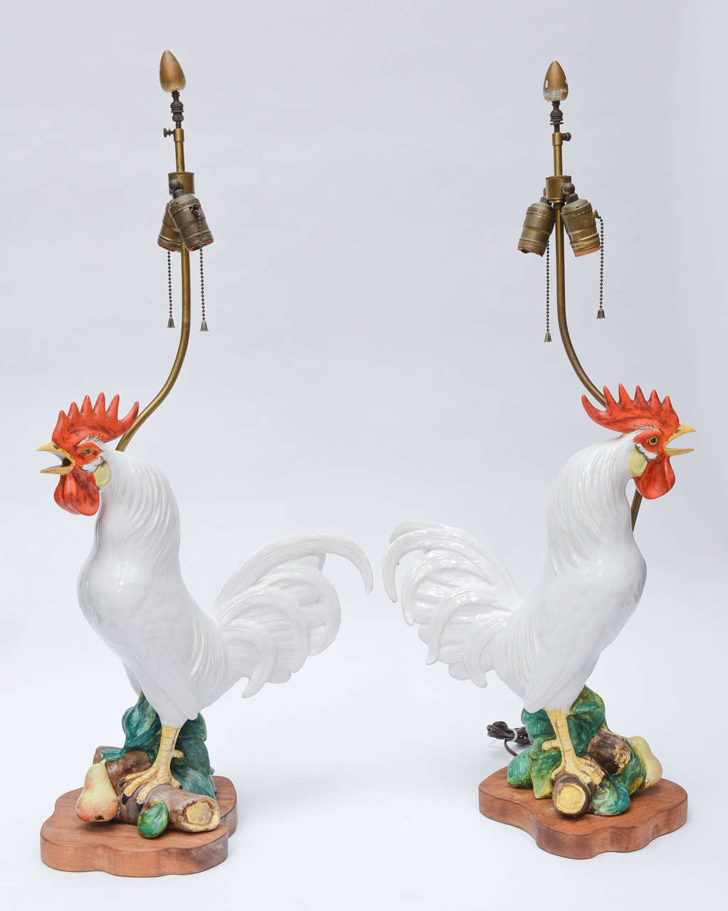 Fabulous pair of large painted Italian ceramic rooster lamps on wood bases. (Sold with out shades)