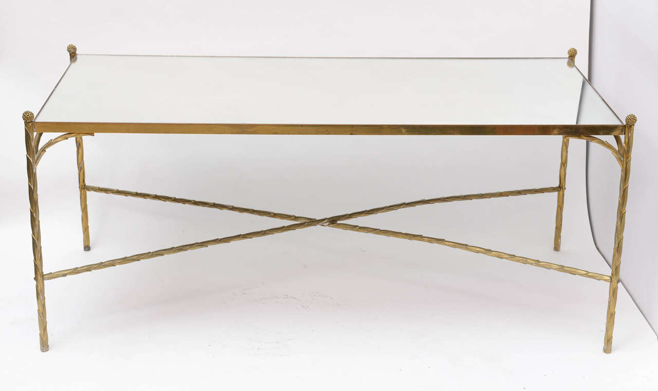 Stylish and clean design brass coffee table with mirrored glass top.