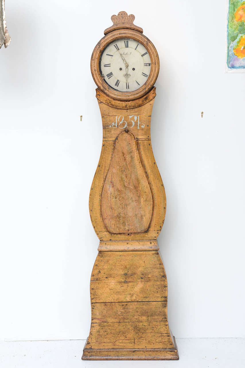 Rare Swedish floor clock, wood carved with ornate finial top. Original finish. The clock opens on the front. The face of the clock has a marking 