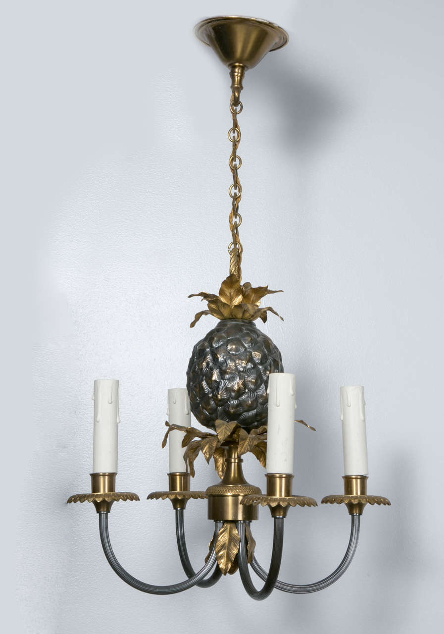 Pretty and small chandelier by Maison Charles with a pineapple, steel and gold. 
Brass and bronze.
Quality made, with four lights.