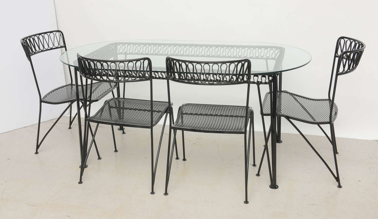 Iconic ribbon pattern dining table with four chairs manufactured by Salterini.
The chairs measure: 33