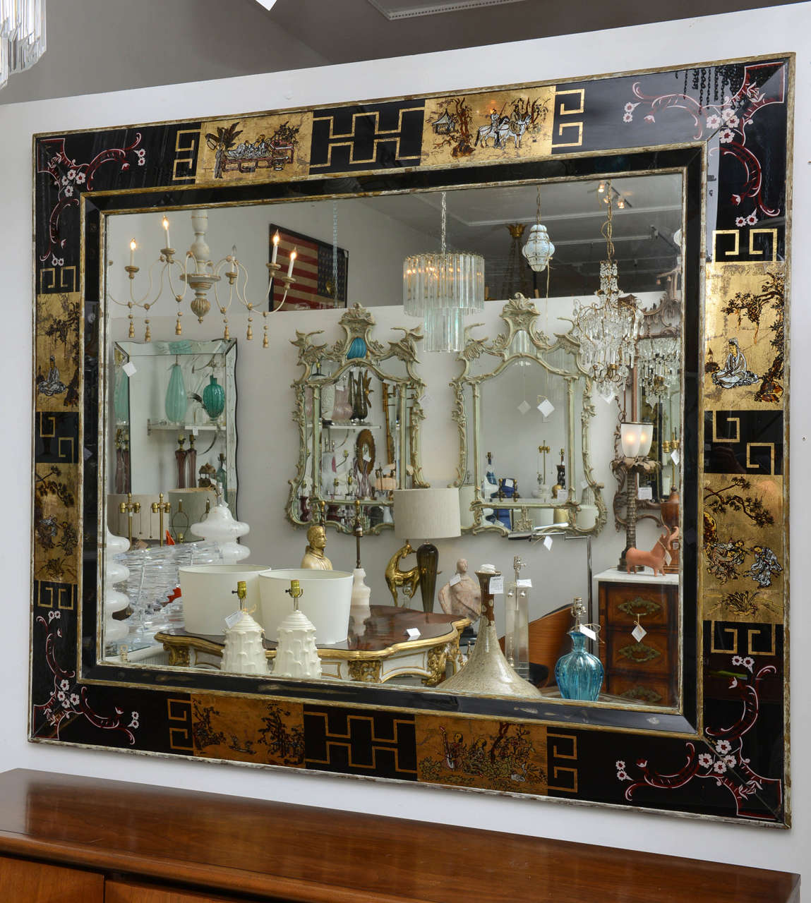 Large and bold reverse painted shadowbox mirror with Asian motif. The black and gold palette is accented with deep red.