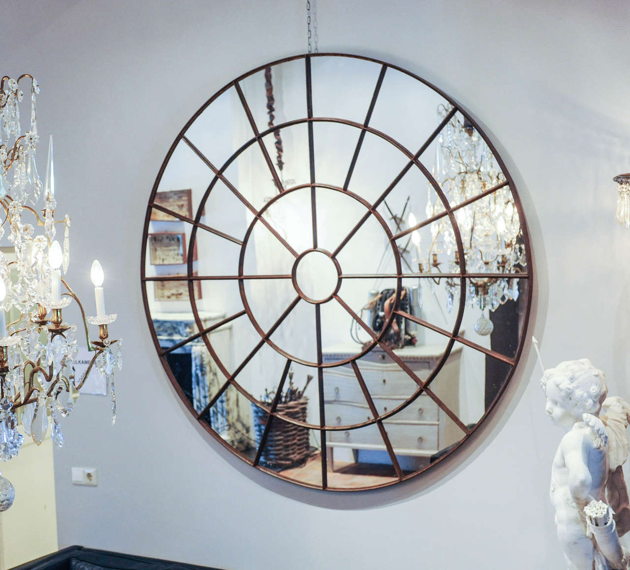 A large round mirror made of an early 20th century cast iron window frame, three pieces available in different sizes: 134,2 cm. (€995,-), 161 cm. ∅ (€1.295,-) and 171,2 cm. ∅ (€1.295,-).