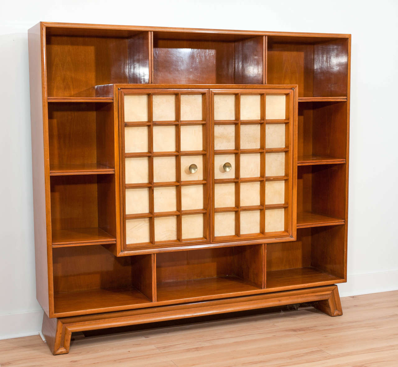 Walnut bookcase cabinet with two central doors covered with parchemin.  Brass handle. In the style of Osvaldo Borsani.