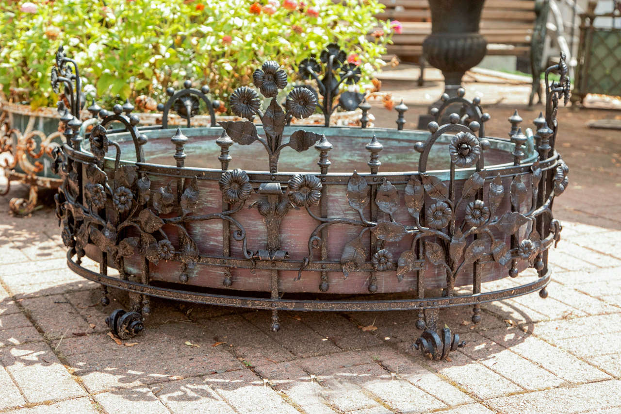 Iron Jardiniere of oval form, railed frame with knopped and ball finials: Applied with floral and foliate mounts. Stands on bifurcated scroll feet. Sotheby's Bilinghurst appraisal of $9000.00 on May 26,2011. Sotheby's states that this beautiful work