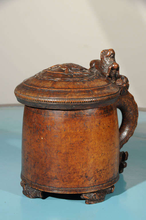 a Norwegian burled wood tankard with lions carved on both the finial and handle