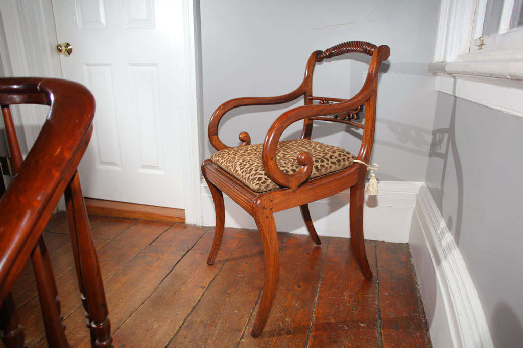 Chinese Export Carved Hardwood Open Armchair made for the American Trade, having an arched  scroll fluted top rail above a rectangular splat having a plain circular plaque flanked by stylized acanthus leaves with downward scrolling arms, caned seat,