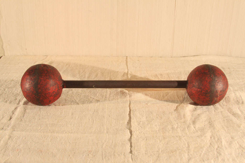 Wacky American Carnival or Circus Barbell made of steel rod and red-painted spheres.  Practical size but substantially heavy.