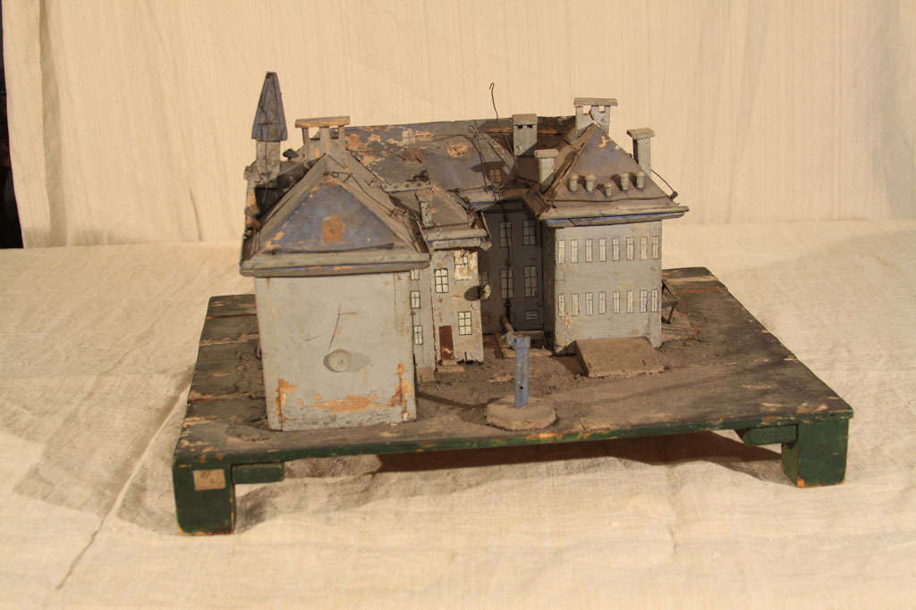 freaky, spooky yet whimsical carved and painted model of a late 19th century/turn of the century institutional building, possibly a sanitorium.  Painted windows and carved chimneys with rooftop vents, eaves andwires all over.  A charming primitive