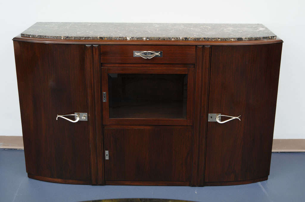 Mahogany middle size French Art Deco sideboard. Excellent and high quality craftsmanship. Superb mahogany and interesting hardware.
Dry bar in the middle part. Beautiful marble top.
Varnish to renovate