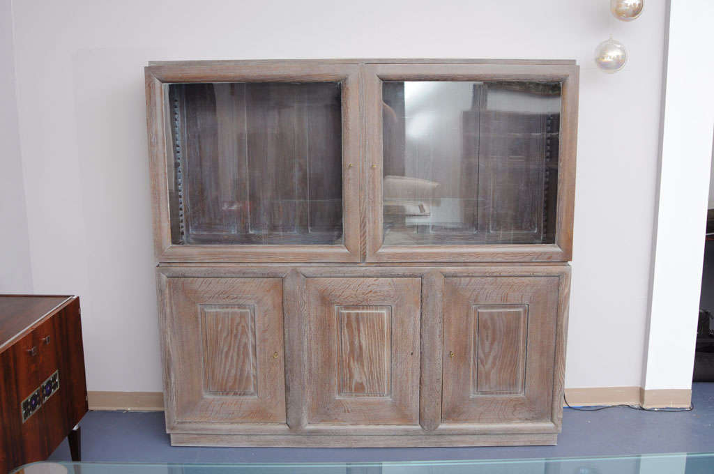 Cerused golden oak vitrine book-case. The highest part is a vitrine with glass doors.
Two wooden shelves in each one of the highest parts of the vitrine and the lowest part has wooden shelves on each part, as well.
Perfect craftsmanship.