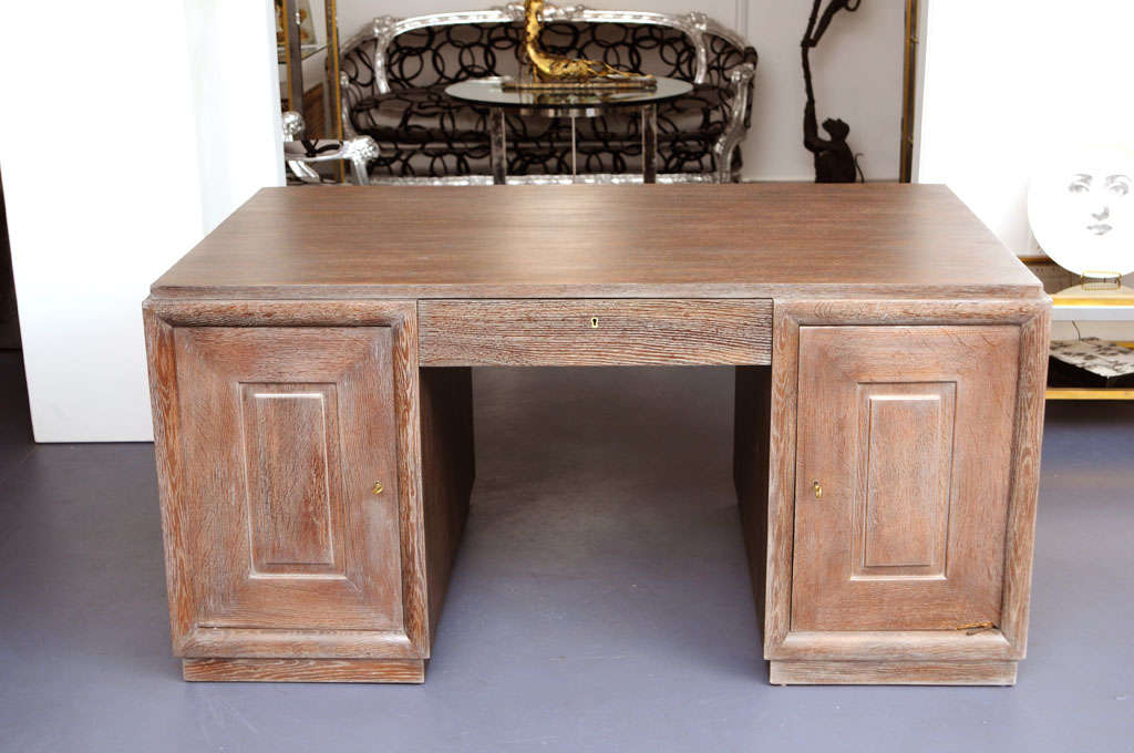 Double-sides cerused golden oak desk, pure and modern design in the style of Charles Dudouyt.
Cerused high quality golden oak. Rows of drawers on each side (front and back) and right and left side. The design is simple but with very refined and