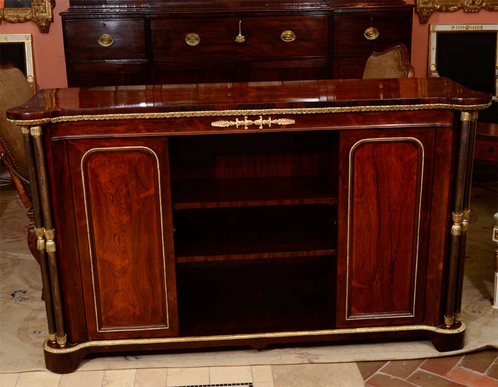 A fine George IV rosewood bronze-mounted credenza with rare steel double column supports.