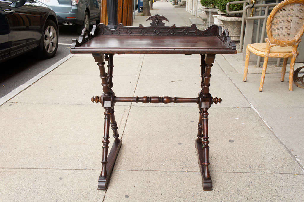 This lovely walnut tray table made in a Black Forest style has simple but elegant carving around the inner and outer tray area. Raised up on finely turned x -shaped legs supported on runners the table is sturdy and yet not heavy and blocky.  The