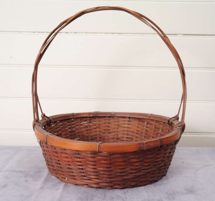 An assembled collection of hand woven baskets from Japan. Woven split reed construction, each basket has a unique design. These baskets were popular imports during the American Arts and Crafts Movement at the turn of the 19th/20th Century. They are