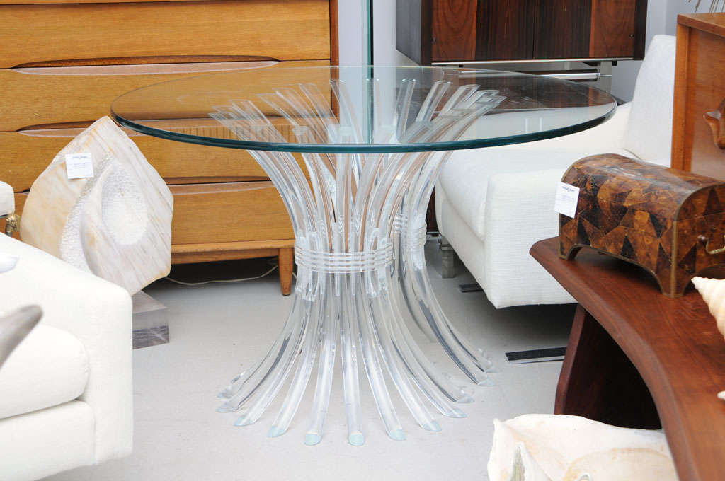 Lucite sheath of wheat table base- comprising two parts which may be arranged as a circle or oval.  The table is currently sold as a circle with circular glass top.