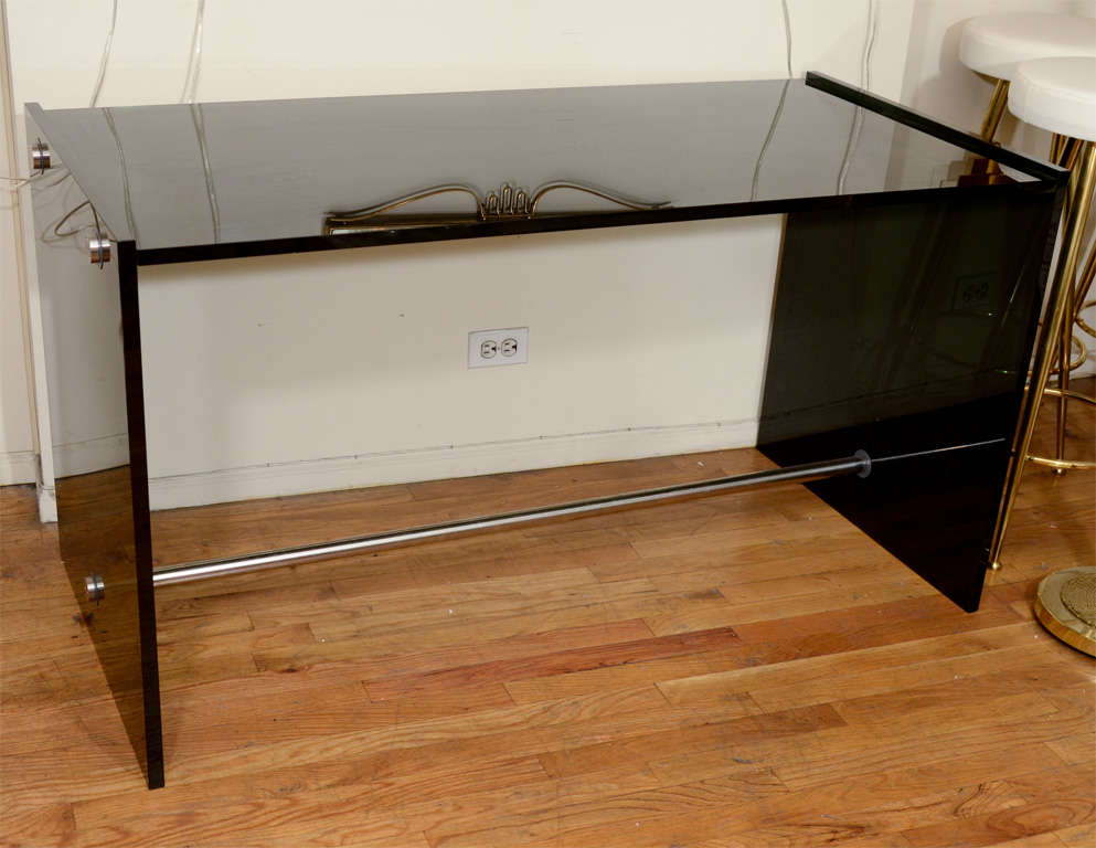 Desk composed of smoked glass slabs featuring a subtle iridescent finish with stainless steel crossbar supports.

View our complete collection at www.johnsalibello.com