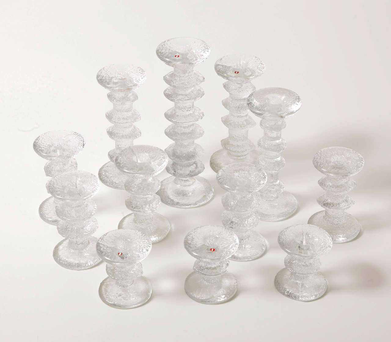 A set of twelve glass candleholders 'Festivo' by Timo Sarpaneva.
Produced by Littala.
Four sizes.
H. 8.5 x diam. 7.2 cm (3x).
H. 12.5 x diam. 7.5 cm (5x).
H. 18.5 x diam. 8.5 cm (3x).
H. 25 x diam. 9.2 (1x).
Vintage.