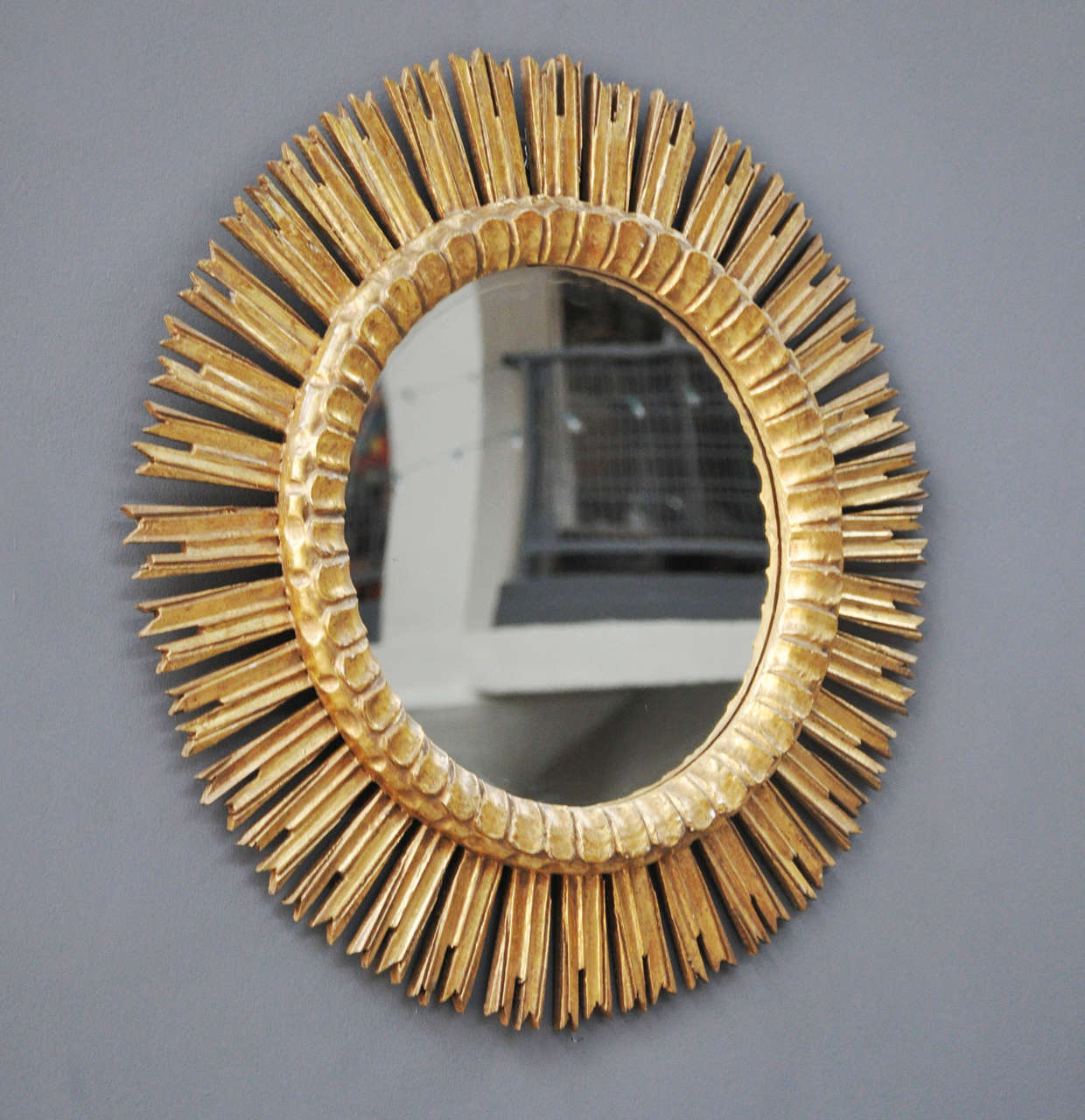 A mid-20th century French gold leaf sunburst mirror.