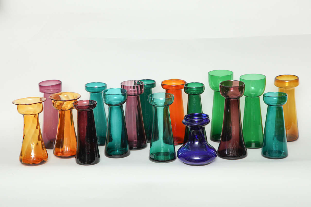 Fine assortment of English early 19th to early 20th Century colored glass bulb or hyacinth vases, in various gem tone colors such as emerald green, amethyst, amber, aquamarine, topaz and cobalt blue, including a swirled amber pair and an emerald