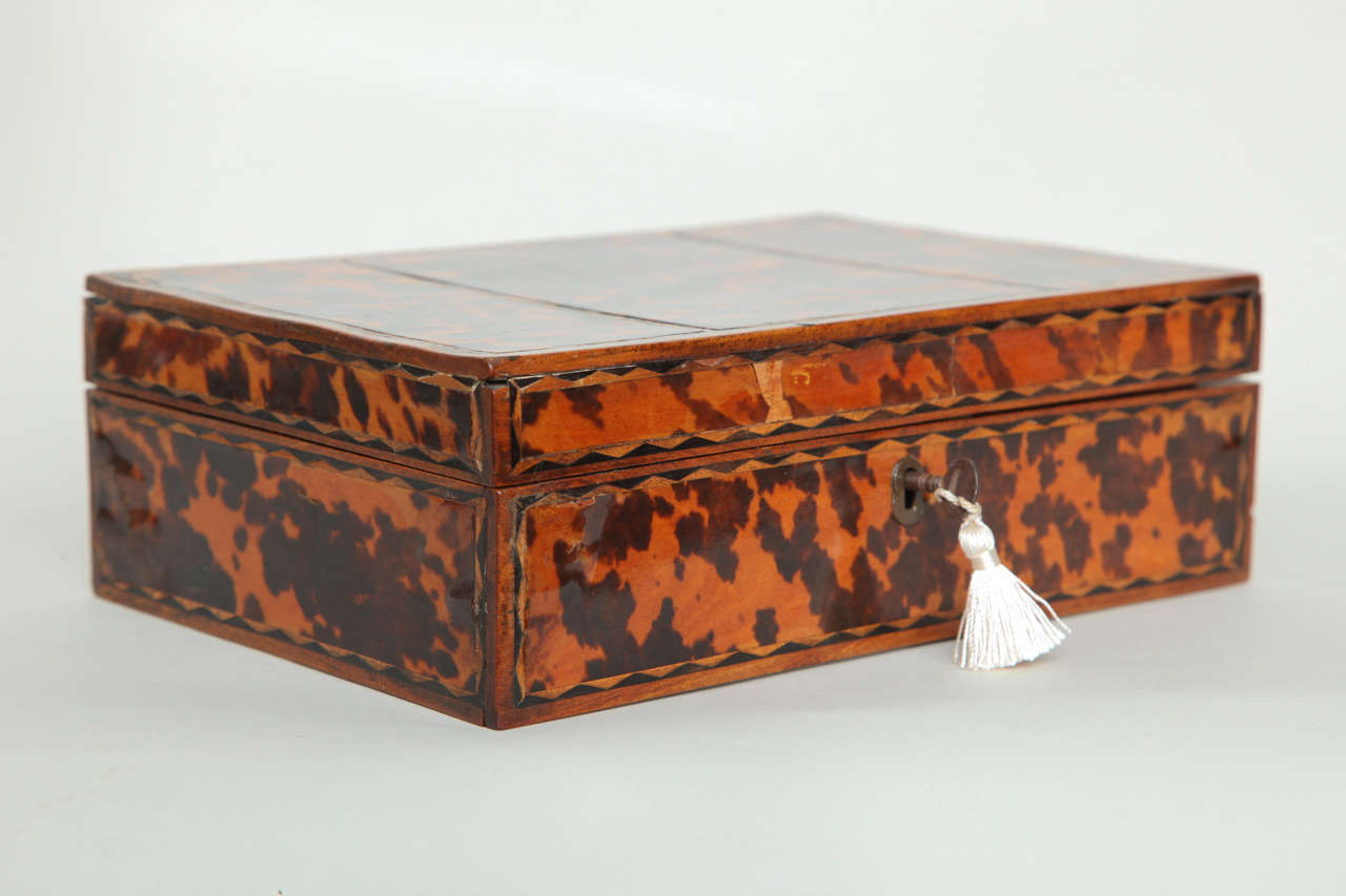 Charming early 19th century box decorated in faux tortoise shell and having zig zag patterned string inlay, the interior with fitted tray for use as a jewelry or work box and retaining the original compartment lids, the whole removable to reveal