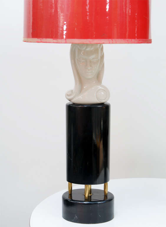 In The Style of Dorothy Draper, Glamour’s Ceramic Maiden Bust Lamps, Mini Head Girls seating on Black lacquered Wood piece and Solid Brass. Red shades add a daring touch.