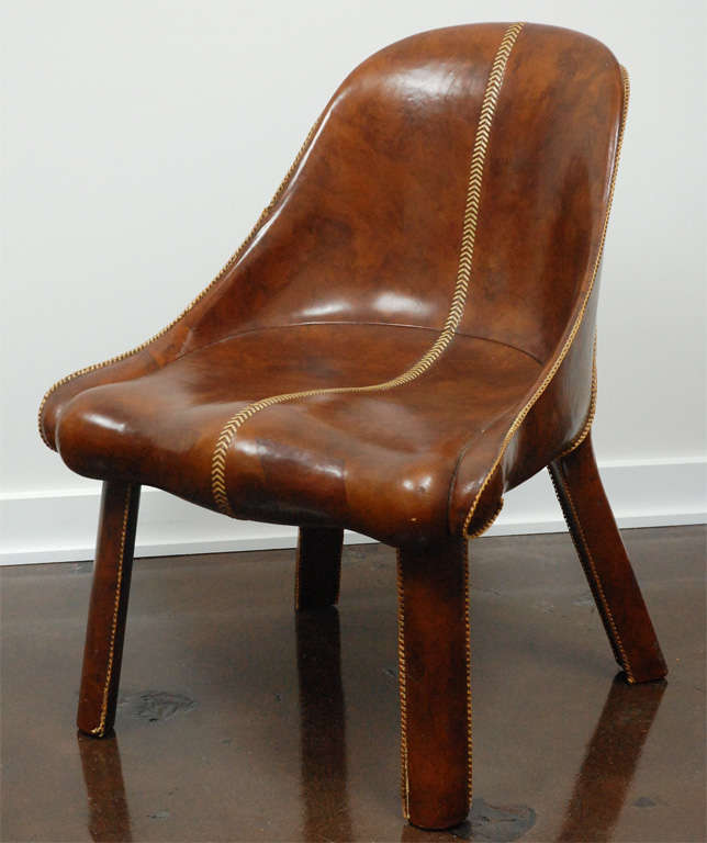 Important pair of leather clad lounge chairs with leather saddle stitching, designed by William Haines in 1939 for the Desert Living Room at the Golden Gate International Exposition.

Haines was known to have produced only four of these chairs two