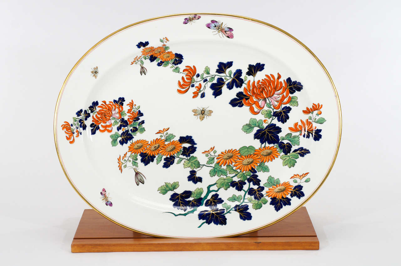 Spectacular large oval porcelain platter with hand painted polychrome enamel decoration in the Imari palette. This beauty is embellished with gold trim and highlighted with bees and butterflies in the 