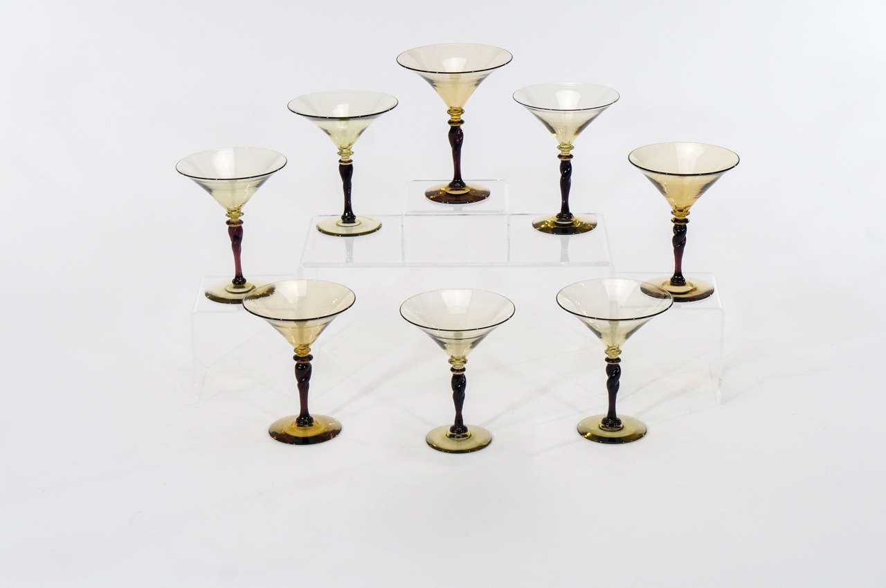An unusual set of eight handblown crystal martini glasses made by Steuben, Carder period, will be perfect for your next party, filled with your favorite drink. The color combination of amethyst and topaz also make a wonderful decorative statement