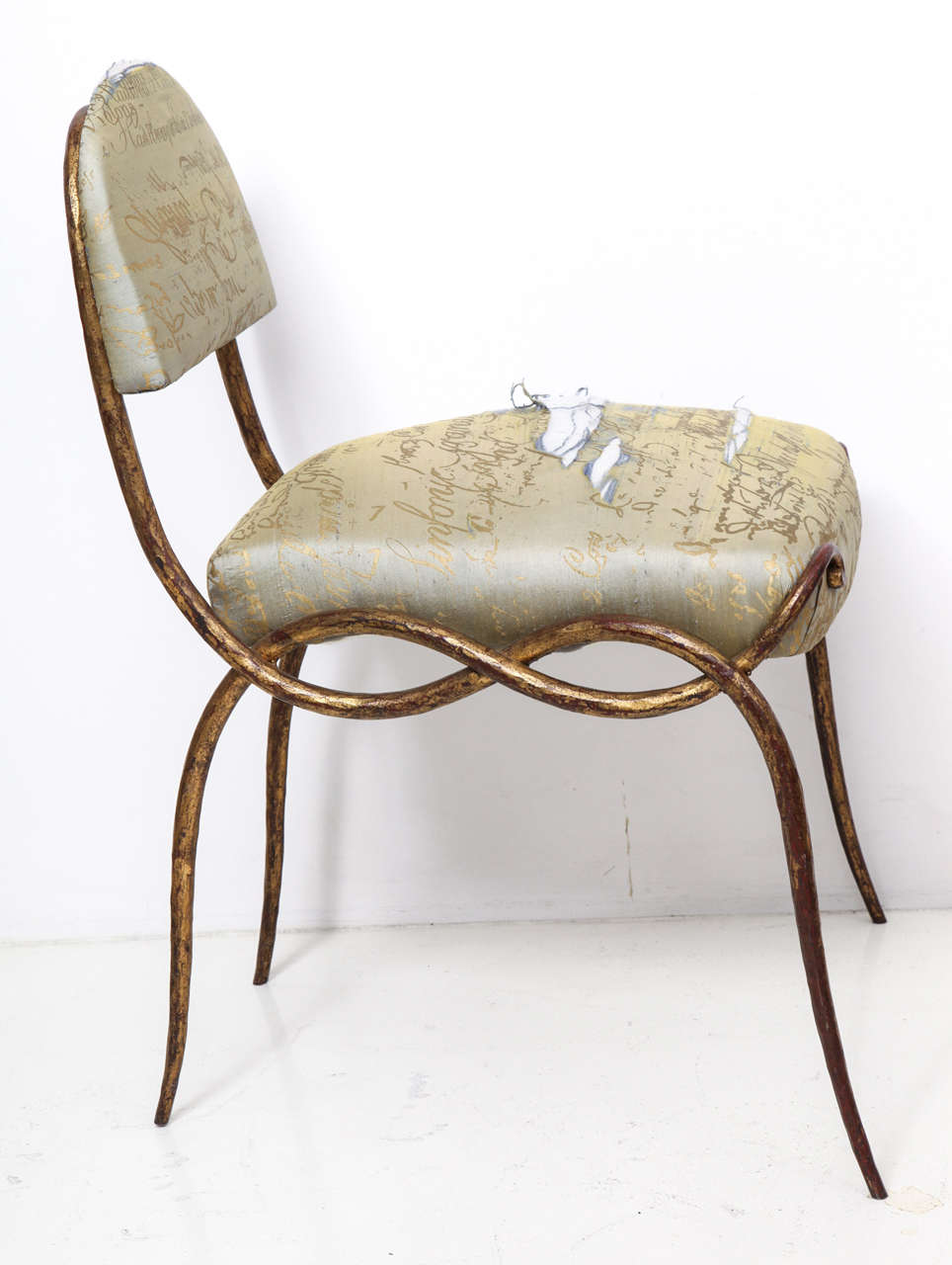 René Drouet (1899–1993) 
Side chair in scrolling ironwork with gilded finish.
Low rounded back makes it a perfect vanity chair.
Requires reupholstery.
French,. c. 1940