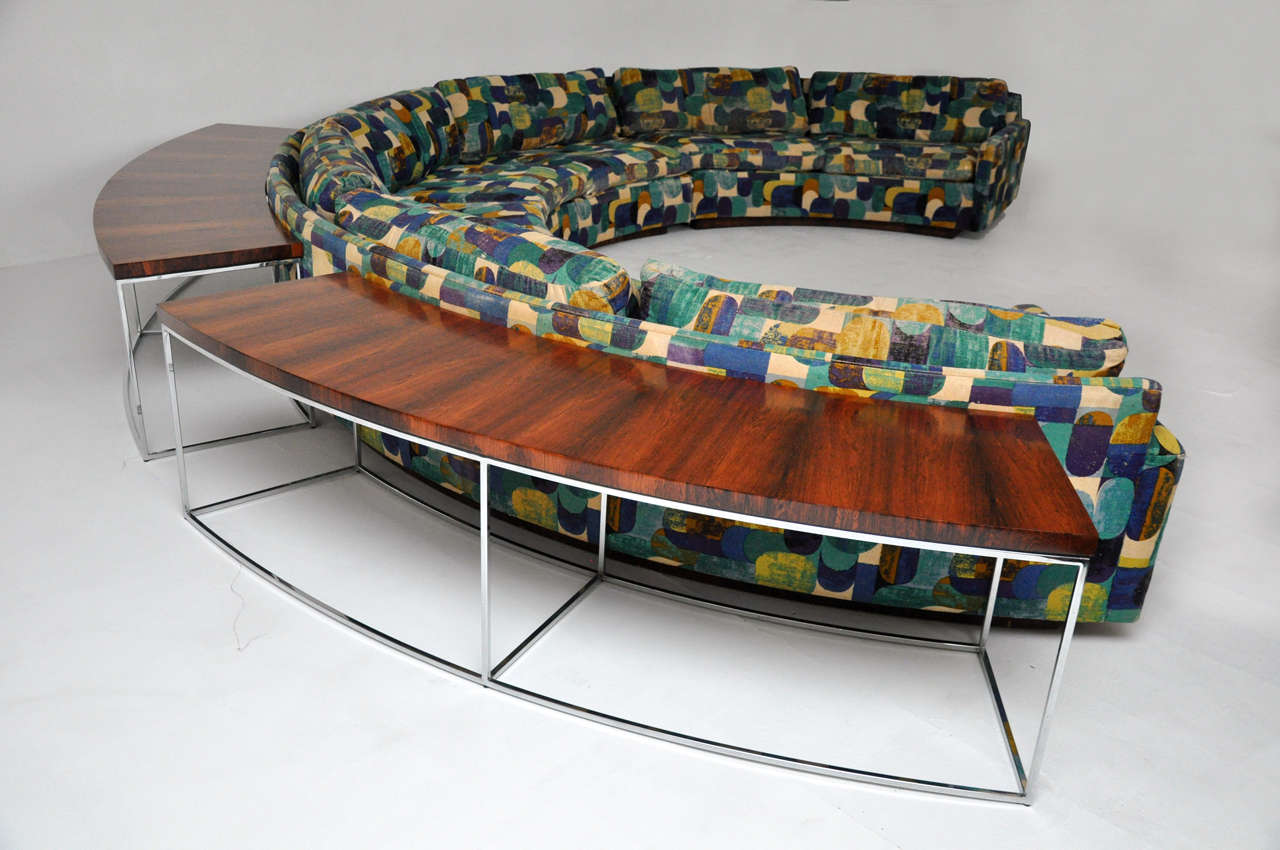 Large semi-circular sofa by Milo Baughman on rosewood base.  Sofa is in 3 sections.  Pair of rosewood and chrome console tables included.