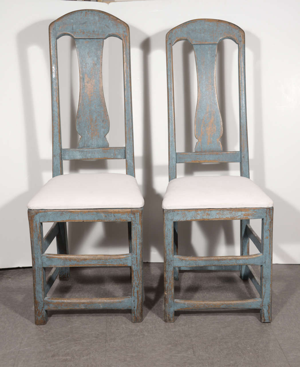 This near pair of bright blue side chairs are perfectly imperfect.  From Sweden's Baroque period (1660-1720) they are folk art, really.  Slightly different in size, very solid and perfectly functional, paint worn where feet rested and hands touched