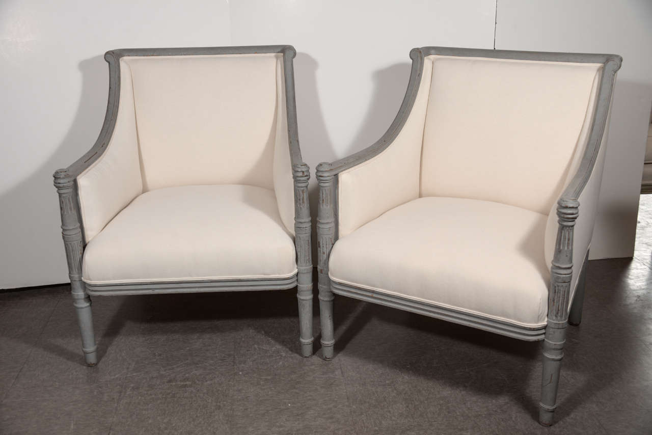 Pair of painted Swedish armchairs with straight lines reminiscent of the Louis XVI period, circa 1880.  New upholstery in white canvas (can be left as is or easily reupholstered).  Graceful lines make them attractive from any angle.