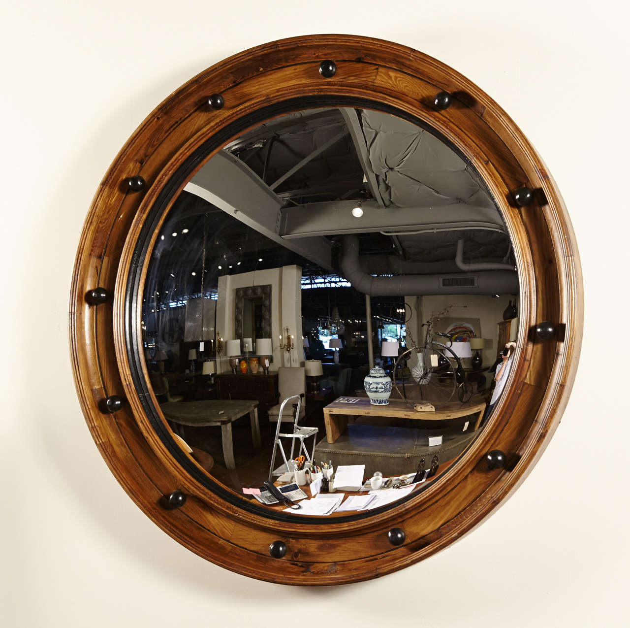 Elegant coastal decor style of pine wood wall mirror 
Convex mirror in reclaimed english pine frame
Reclaimed with light blonde tones of pine wood coloration 
Rivet nautical look of black balls placed around the mirror 
Weight: 60lbs  Origin: