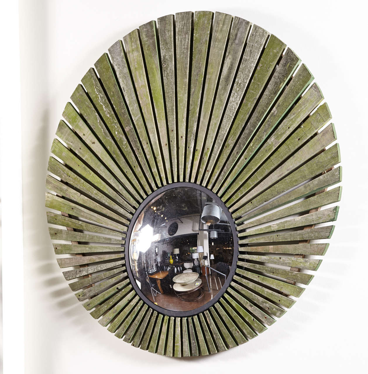 London Teak Sunburst Mirror
Weathered Teak Slats from a London park bench used to create a sunburst mirror
Mirror is placed off center to create dramatic and curiosity aesthetic
Color tones of Grey & Green