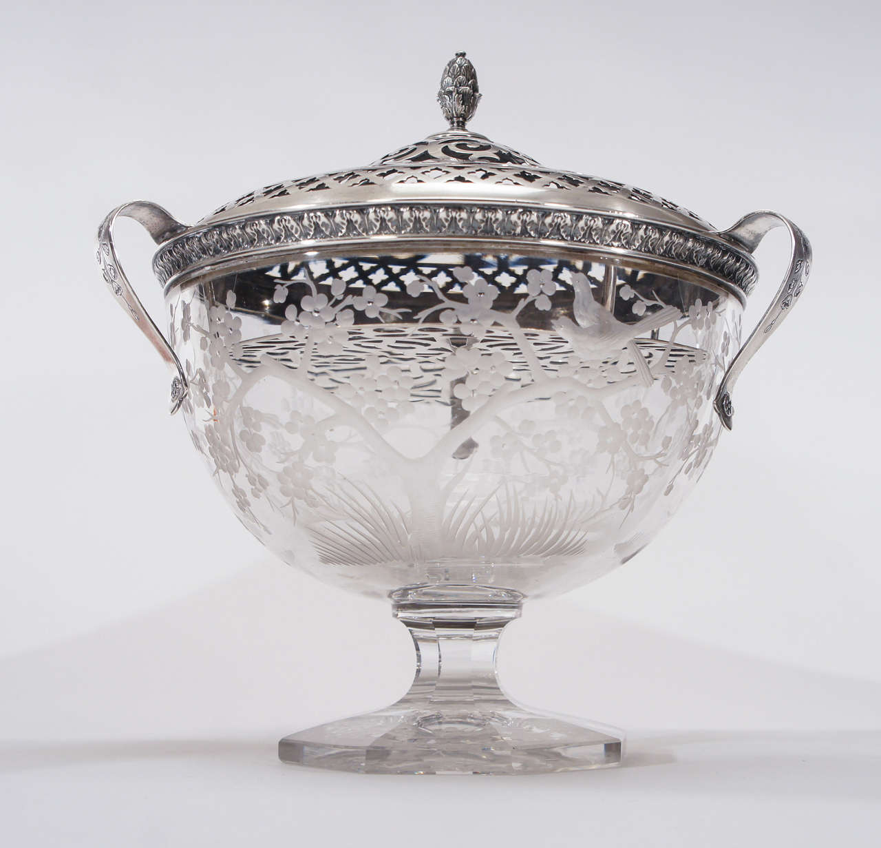 A rare and perhaps unique footed centerpiece most certainly made by Hawkes in Corning NY. in the Aesthetic Movement style.
The heavy crystal is decorated with copper wheel engraved birds and  cherry blossoms and sits on an octagonal base. The bowl
